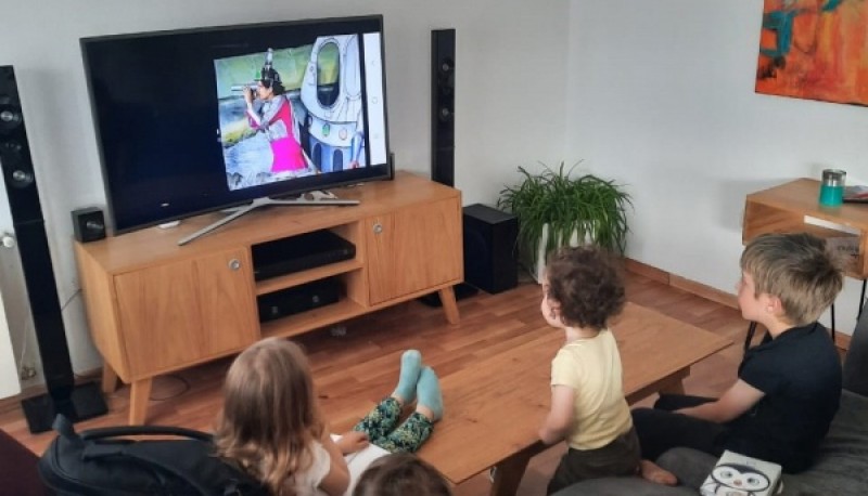 Un grupo de niños presencia desde el hogar la función virtual de la obra de teatro ambiental “Odisea por sobrevivir”.